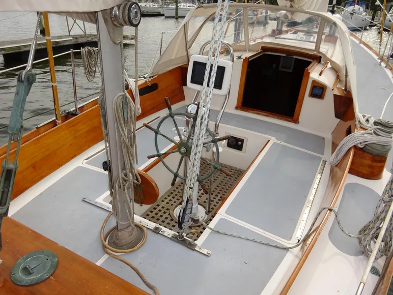 Slide: The Image of 1964 Hinckley Bermuda 40 Custom sailboat cockpit with wooden accents and steering wheel. - 26