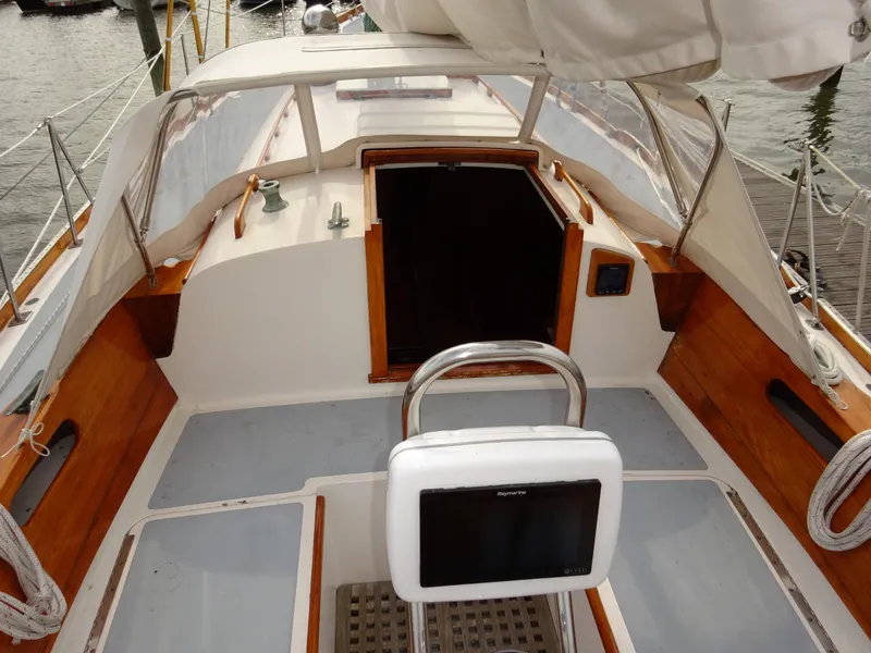 Slide: The Image of 1964 Hinckley Bermuda 40 Custom sailboat cockpit with wooden accents and navigation equipment. - 29