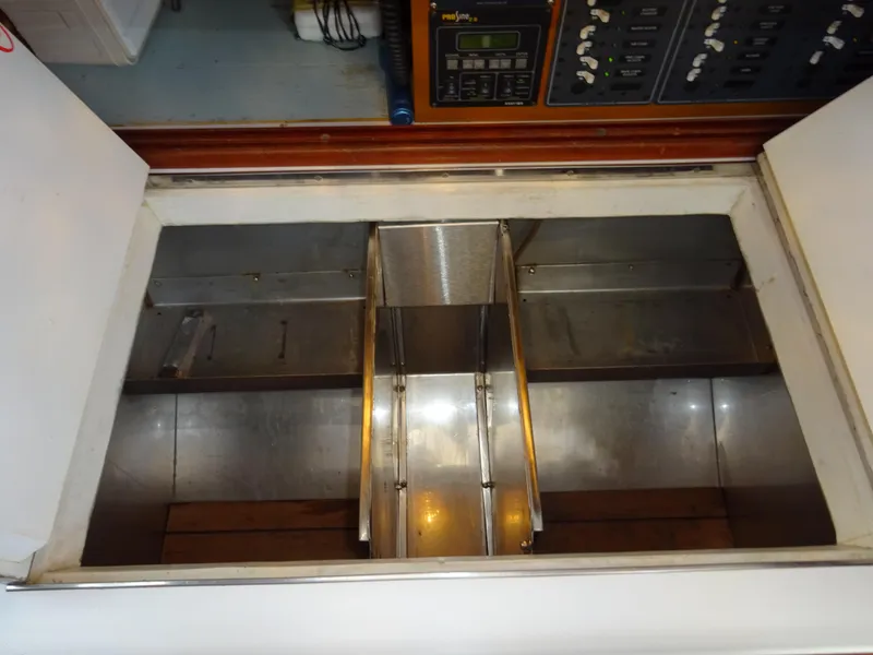 Slide: The Image of Storage compartment inside a 1964 Hinckley Bermuda 40 Custom yacht, featuring metal dividers. - 39