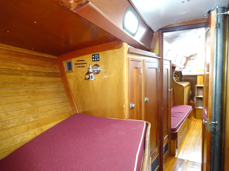 Slide: The Image of Interior of 1964 Hinckley Bermuda 40 Custom sailboat with wooden finish and red cushions. - 45