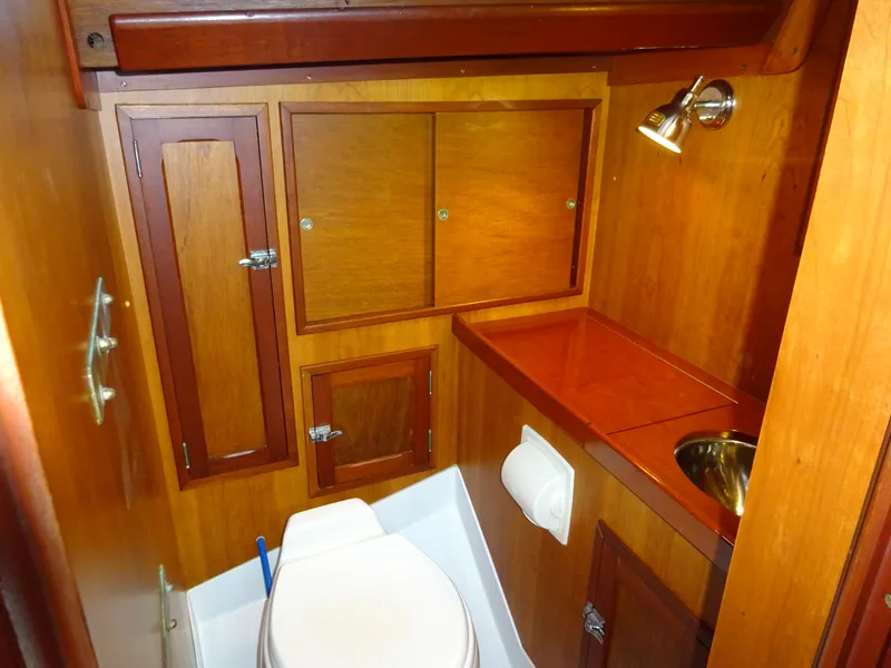 Slide: The Image of Hinckley Bermuda 40 Custom 1964 yacht bathroom with wooden cabinetry and compact design. - 46
