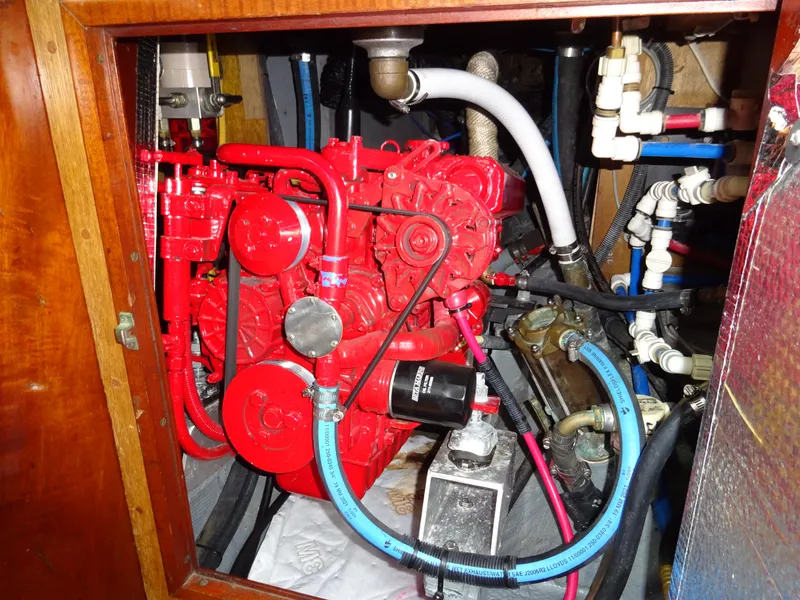 Slide: The Image of Engine compartment of a 1964 Hinckley Bermuda 40 Custom sailboat, featuring a red engine. - 49