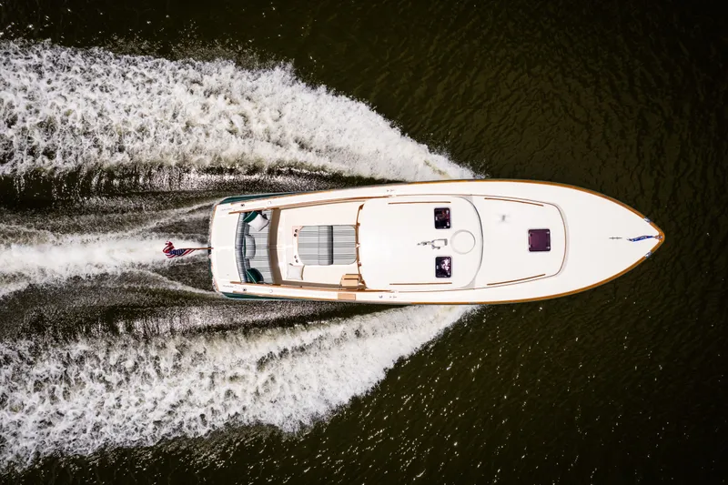 Slide: The Image of Overhead view of 1997 Hinckley Picnic Boat Classic cruising on water, leaving a wake. - 17