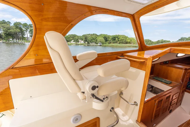 Slide: The Image of Luxurious interior of 1997 Hinckley Picnic Boat Classic with elegant wood finish and plush seating. - 30