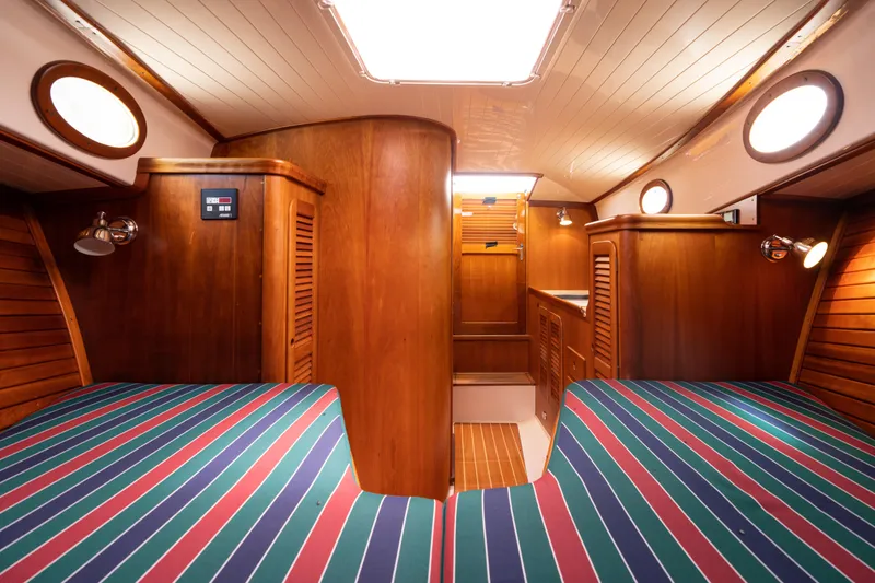 Slide: The Image of Interior of 1997 Hinckley Picnic Boat Classic with wooden finish and striped upholstery. - 41