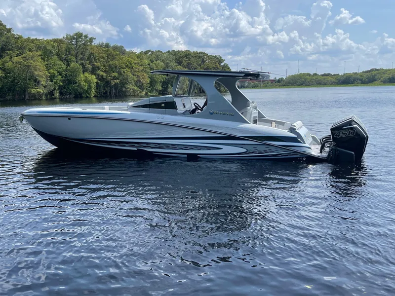 The Image of 2022 Mystic Powerboats M3800 on calm water, showcasing sleek design and powerful engines. - 1