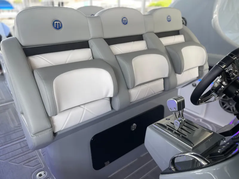 Slide: The Image of 2022 Mystic Powerboats M3800 interior with luxurious seating and modern controls. - 11