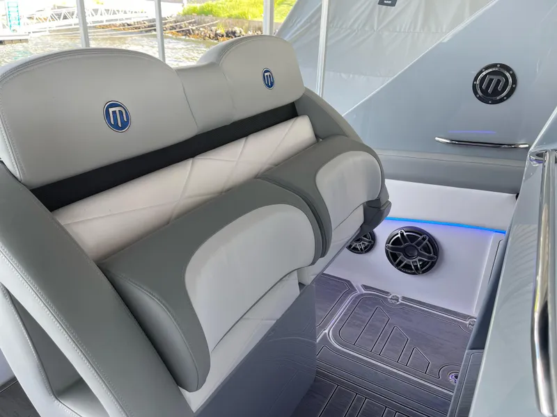 Slide: The Image of 2022 Mystic Powerboats M3800 interior with gray seating and modern design elements. - 13