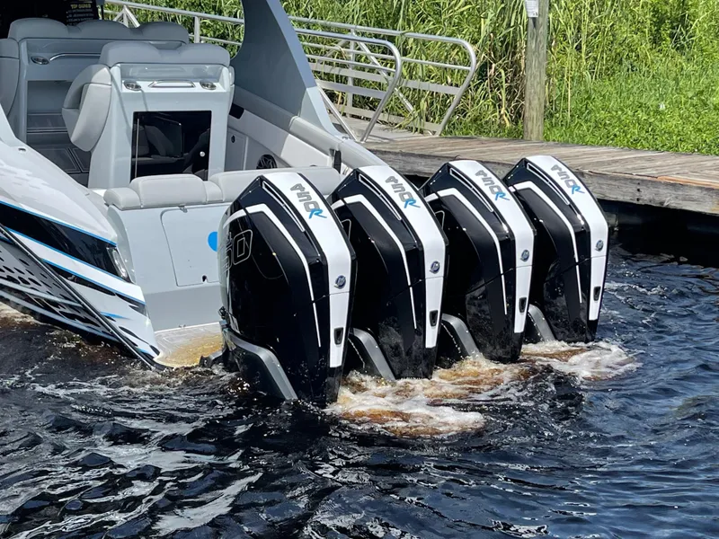 Slide: The Image of 2022 Mystic Powerboats M3800 with four powerful outboard engines in water. - 2