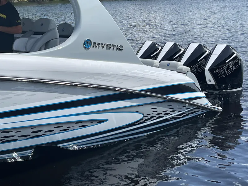 Slide: The Image of 2022 Mystic Powerboats M3800 with sleek design and powerful engines on the water. - 4