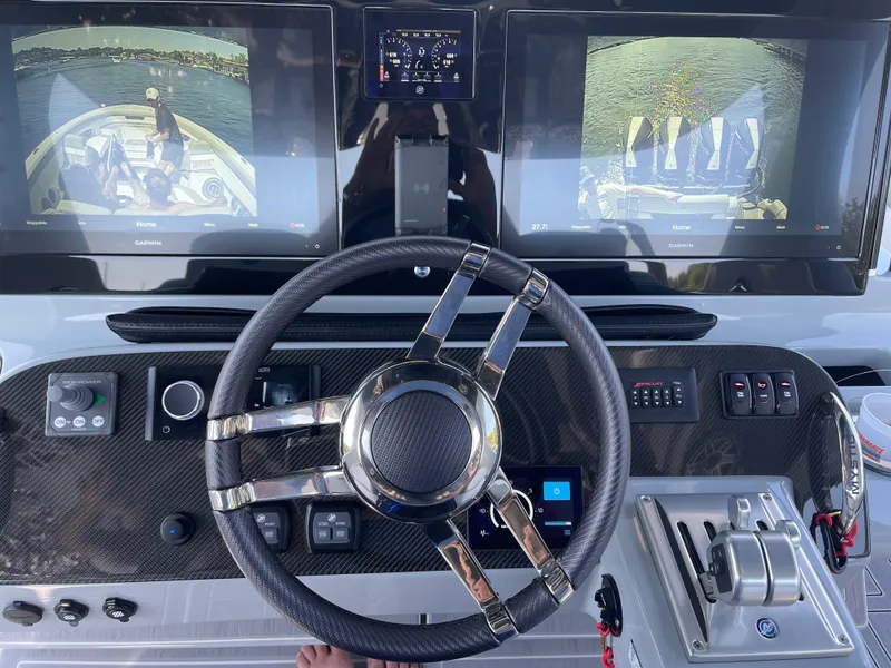 Slide: The Image of Steering wheel and dashboard of 2022 Mystic Powerboats M3800 with dual display screens. - 5