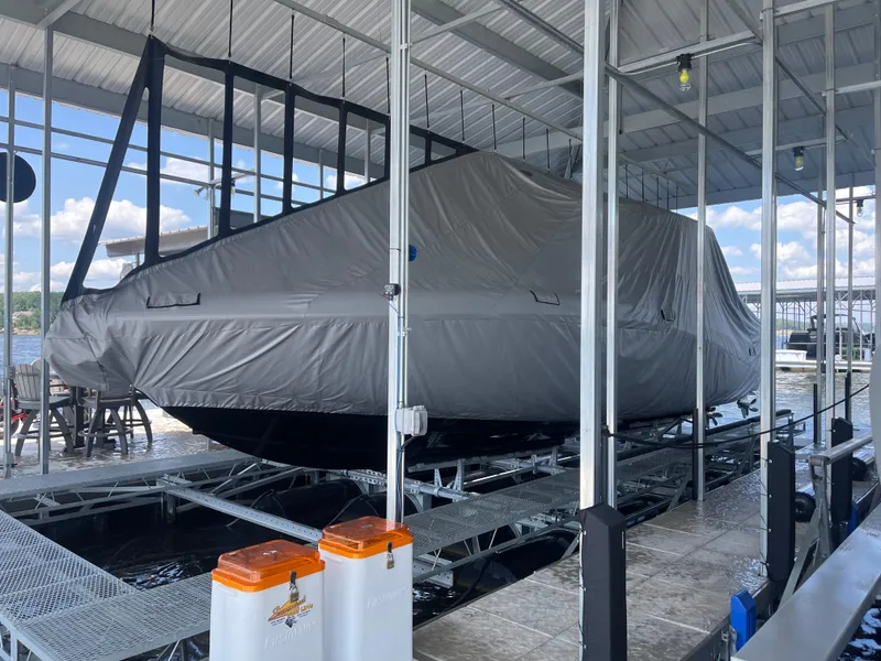 Slide: The Image of 2022 Mystic Powerboats M3800 covered and docked in a marina. - 6