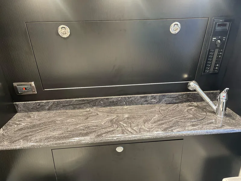 Slide: The Image of 2022 Mystic Powerboats M3800 interior with sleek countertop and modern fixtures. - 8