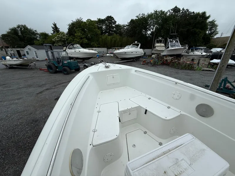 Slide: The Image of 2004 Sailfish 266 CC boat in a marina with other vessels and equipment. - 8