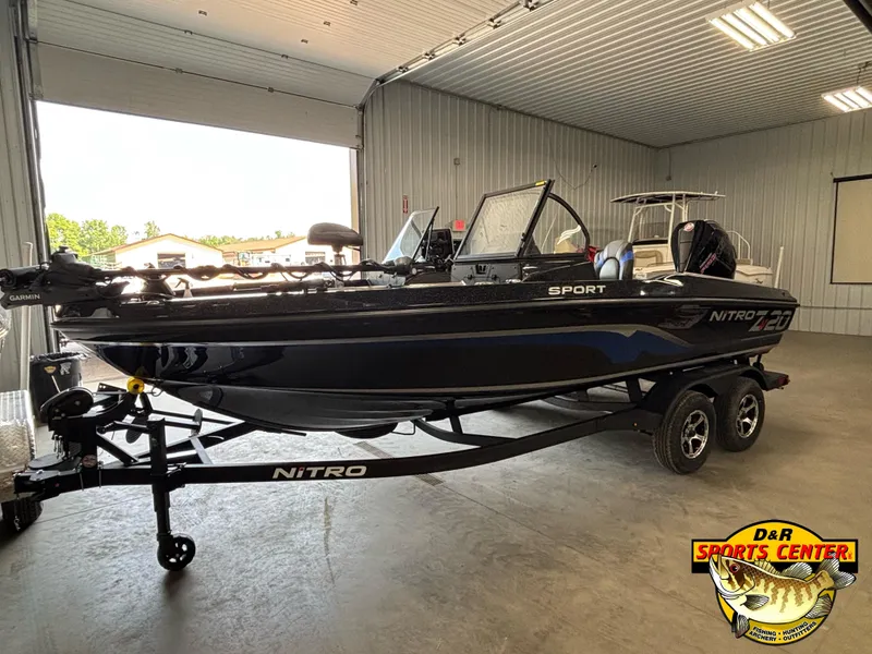 The Image of 2025 Nitro ZV20 Sport Pro boat in showroom, black exterior, on trailer. - 0