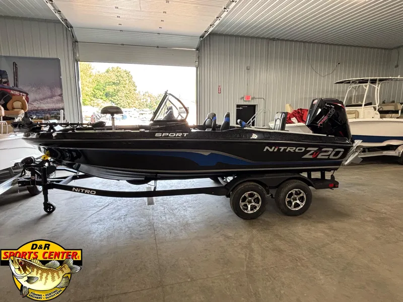 Slide: The Image of 2025 Nitro ZV20 Sport Pro boat in showroom, side view, on trailer. - 2