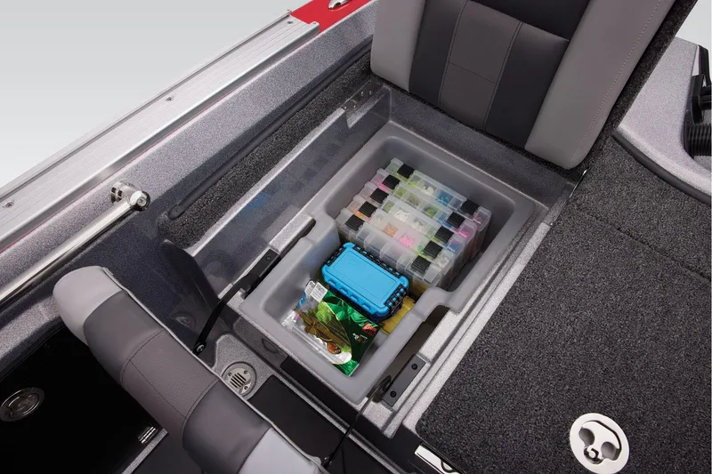 Slide: The Image of 2025 Nitro ZV20 Sport Pro boat storage compartment with organized tackle boxes. - 23