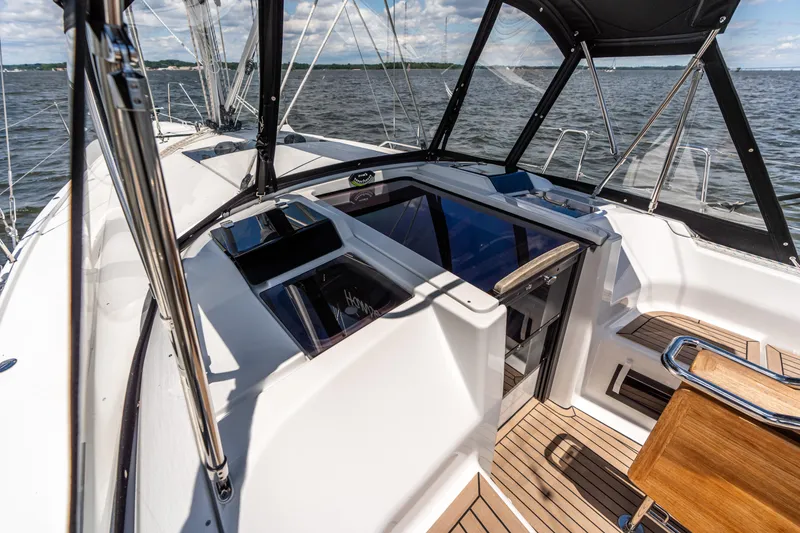 Slide: The Image of 2023 Hanse 348 yacht cockpit with sleek design, wooden flooring, and ocean view. - 14