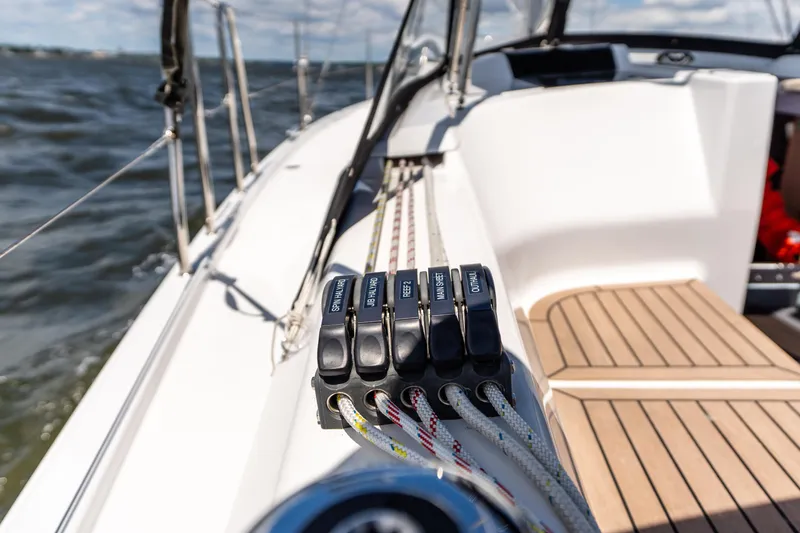 Slide: The Image of 2023 Hanse 348 sailboat deck with control lines and ocean view. - 15