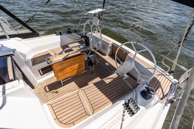 Slide: The Image of 2023 Hanse 348 sailboat cockpit with dual steering wheels and teak flooring on the water. - 17