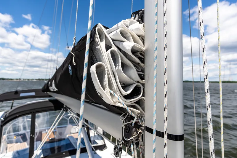 Slide: The Image of 2023 Hanse 348 sailboat mast and rigging against a cloudy sky on the water. - 24