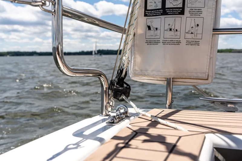 Slide: The Image of Sailing on a 2023 Hanse 348 yacht, featuring deck details and safety instructions. - 27
