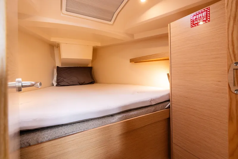 Slide: The Image of Cozy cabin interior of 2023 Hanse 348 yacht with bed and wooden furnishings. - 38