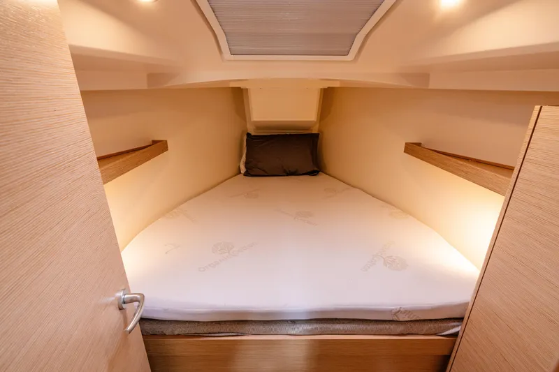 Slide: The Image of Cozy cabin interior of 2023 Hanse 348 yacht with comfortable bed and soft lighting. - 39