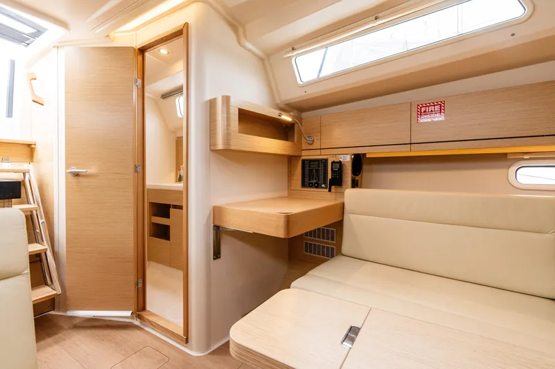 Slide: The Image of 2023 Hanse 348 yacht interior with modern wood finish and seating area. - 41