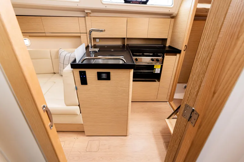 Slide: The Image of 2023 Hanse 348 yacht interior with modern kitchen and seating area. - 45