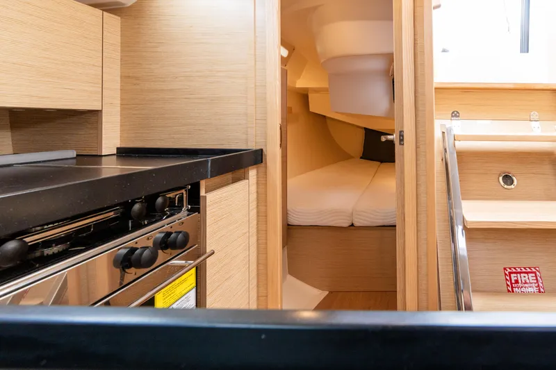 Slide: The Image of Interior of 2023 Hanse 348 yacht featuring a compact kitchen and cozy sleeping area. - 47