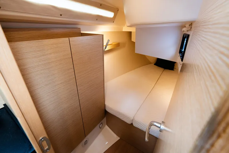 Slide: The Image of 2023 Hanse 348 yacht cabin with cozy bed, wooden interior, and modern lighting. - 48
