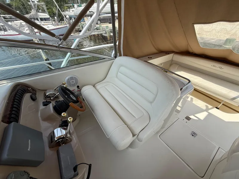 Slide: The Image of 2004 Sea Ray 290 Amberjack helm with white seating and control panel. - 12