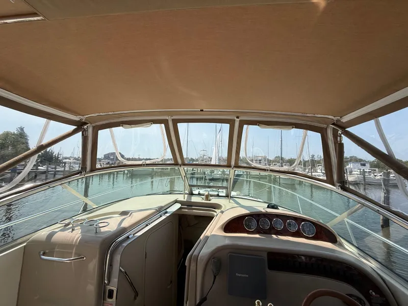 Slide: The Image of 2004 Sea Ray 290 Amberjack boat interior with helm, docked at marina. - 15