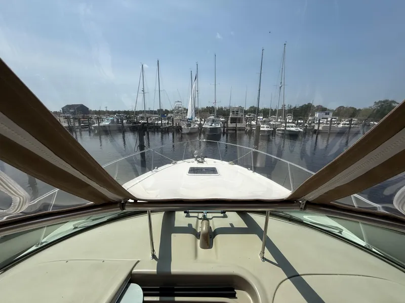 Slide: The Image of 2004 Sea Ray 290 Amberjack boat docked at a marina, view from the helm. - 16
