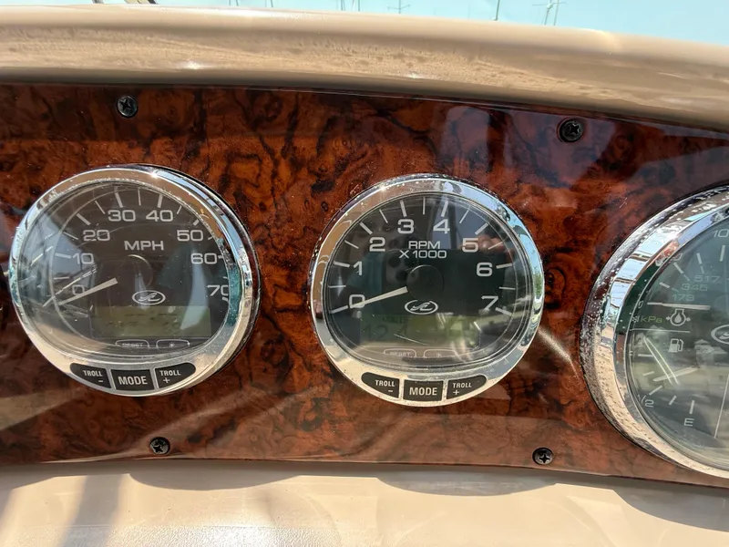 Slide: The Image of Dashboard gauges of a 2004 Sea Ray 290 Amberjack boat, showing speed and RPM. - 17