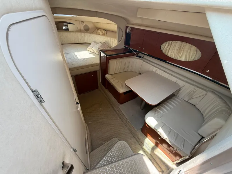 Slide: The Image of 2004 Sea Ray 290 Amberjack cabin interior with seating and sleeping area. - 19