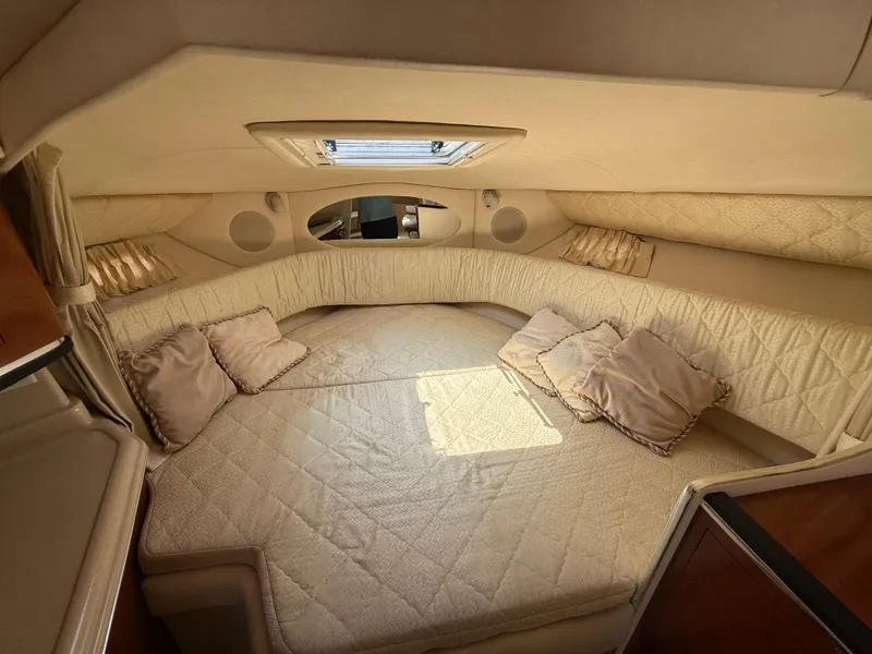 Slide: The Image of Interior cabin of 2004 Sea Ray 290 Amberjack with cozy bedding and cushions. - 21
