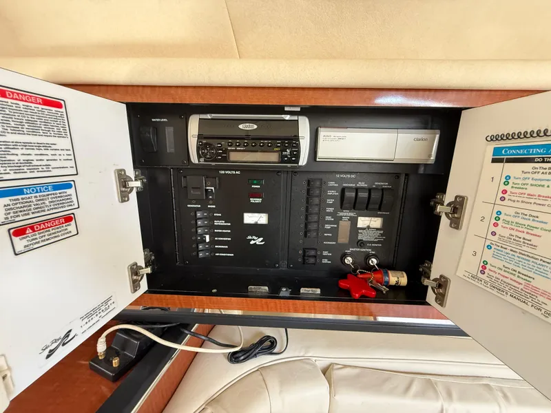 Slide: The Image of Electrical panel inside a 2004 Sea Ray 290 Amberjack boat, featuring various controls and switches. - 26