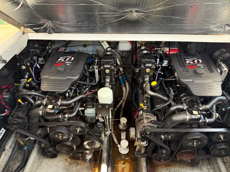 Slide: The Image of Twin engines of a 2004 Sea Ray 290 Amberjack boat, showcasing detailed mechanics. - 30