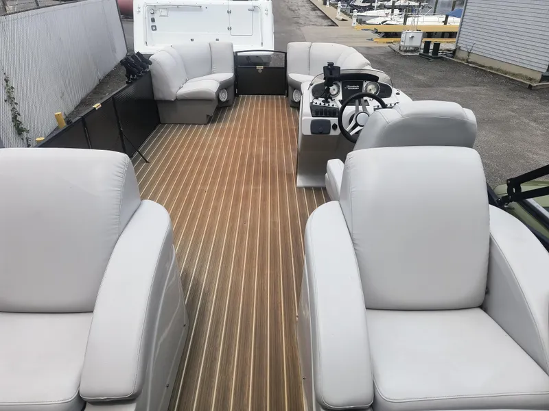 Slide: The Image of 2017 Godfrey Sweetwater Premium Edition 255 SBH pontoon boat with luxurious seating and wood-style flooring. - 5