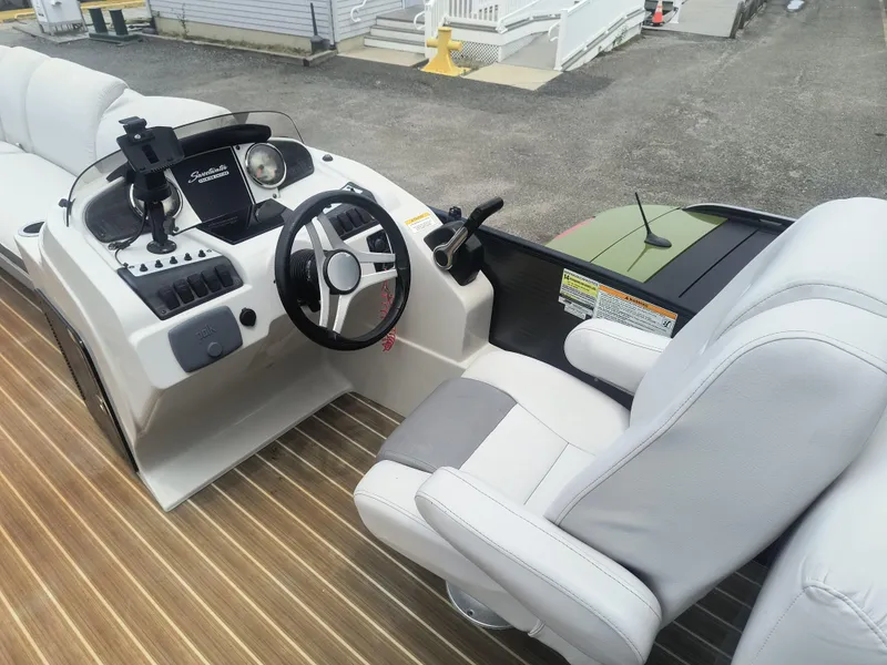 Slide: The Image of 2017 Godfrey Sweetwater Premium Edition 255 SBH boat interior with steering console and seating. - 6