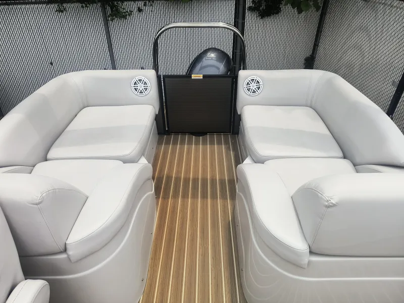 Slide: The Image of 2017 Godfrey Sweetwater Premium Edition 255 SBH boat interior with plush seating and wood-style flooring. - 9