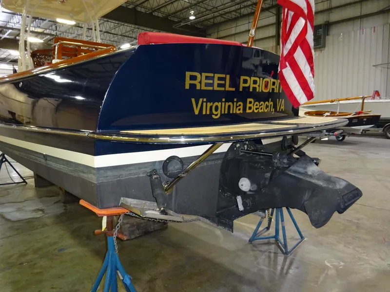 Slide: The Image of Hinckley T29C 2007 boat in a warehouse, Virginia Beach, with American flag. - 14