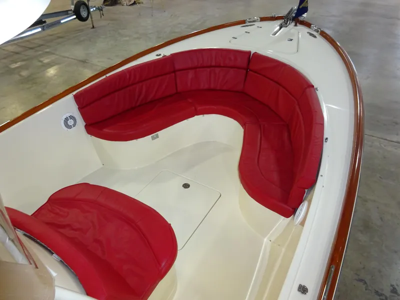 Slide: The Image of 2007 Hinckley T29C boat interior with red cushioned seating in a spacious layout. - 19