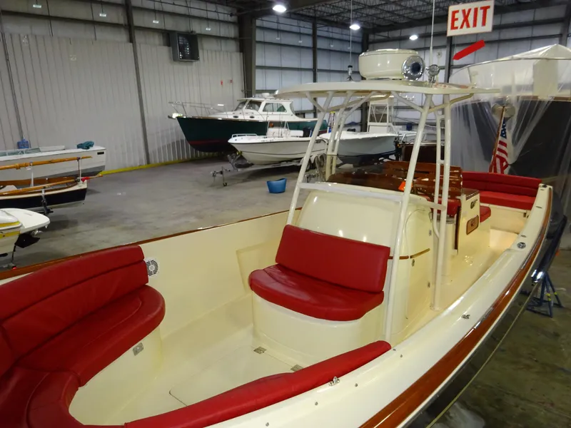 Slide: The Image of 2007 Hinckley T29C boat with red seating in a storage facility. - 2