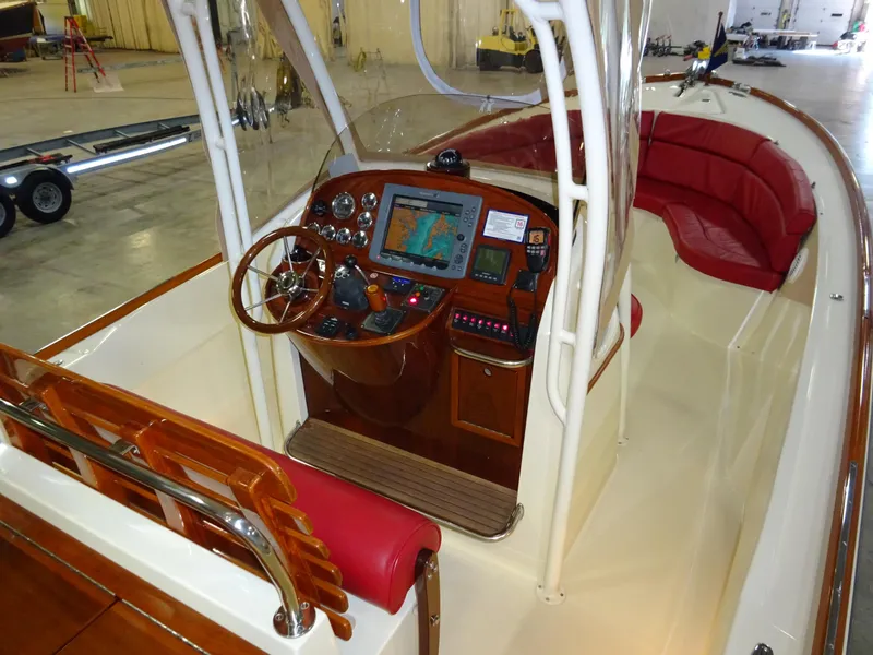 Slide: The Image of 2007 Hinckley T29C boat interior with navigation system and red seating. - 24