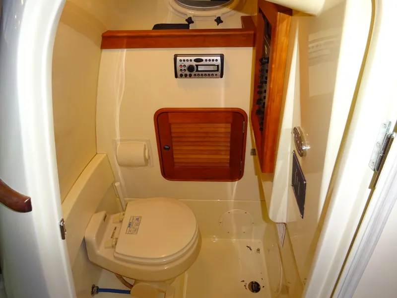 Slide: The Image of 2007 Hinckley T29C boat interior with compact bathroom and wooden accents. - 28