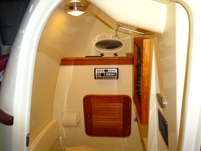 Slide: The Image of 2007 Hinckley T29C cabin interior with wooden accents and control panel. - 29