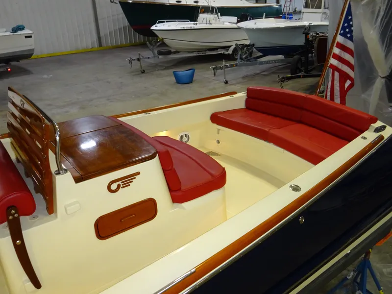 Slide: The Image of 2007 Hinckley T29C boat with red seating and wooden accents in a storage facility. - 3